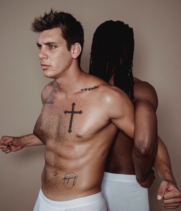 Man performing a controlled squat exercise in a minimalist gym.